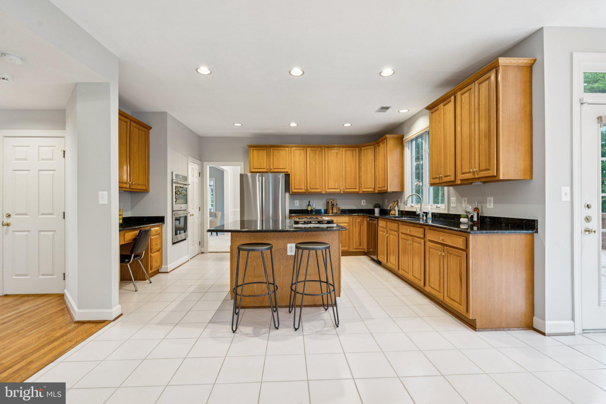 12213 Windsor Hall Way Herndon, VA 20170 - Photo 16 of 64 a kitchen with stainless steel appliances granite countertop a refrigerator and a stove top oven