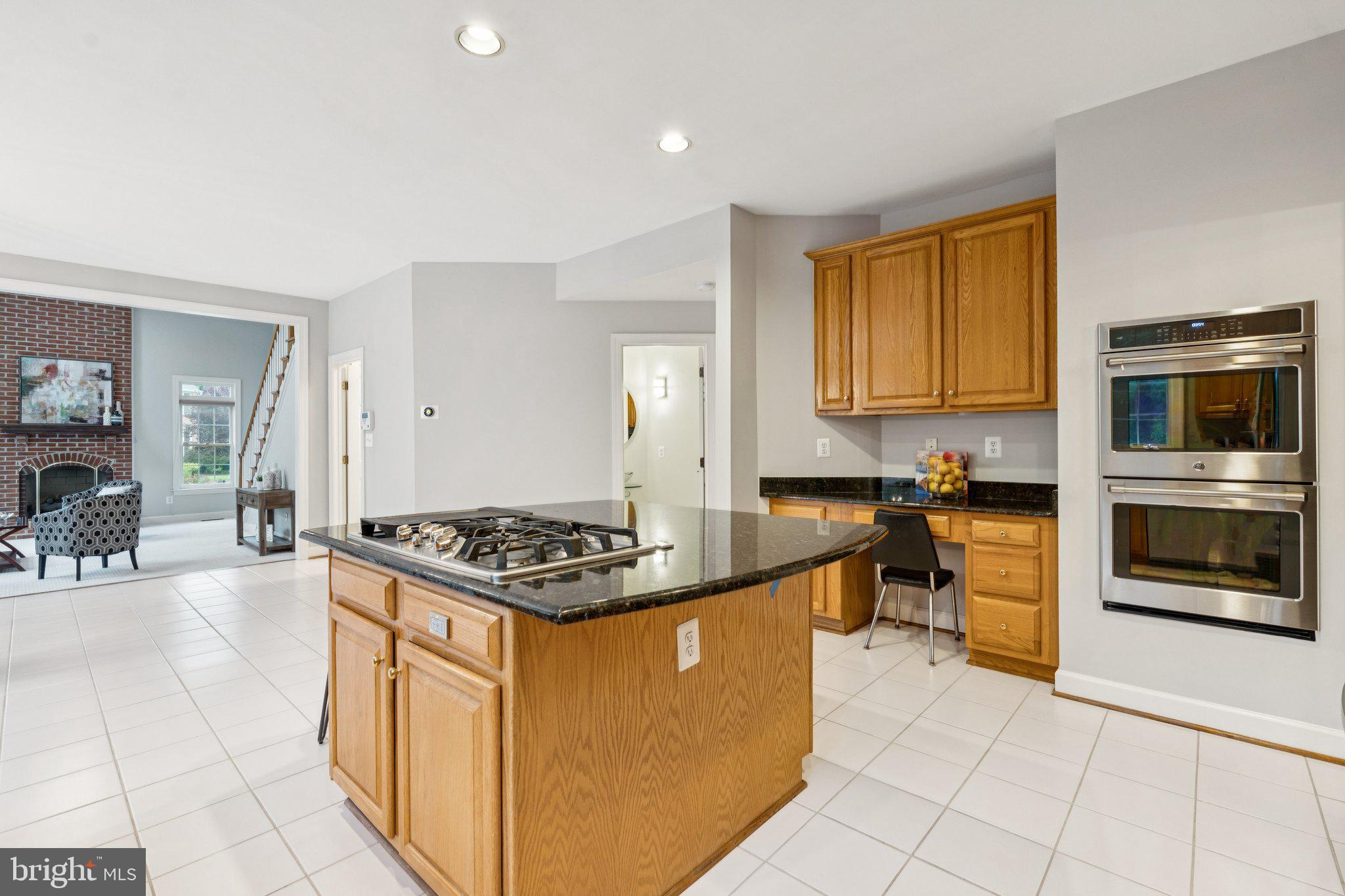 12213 Windsor Hall Way Herndon, VA 20170 - Photo 19 of 64 a kitchen with stainless steel appliances granite countertop a stove a sink and a microwave
