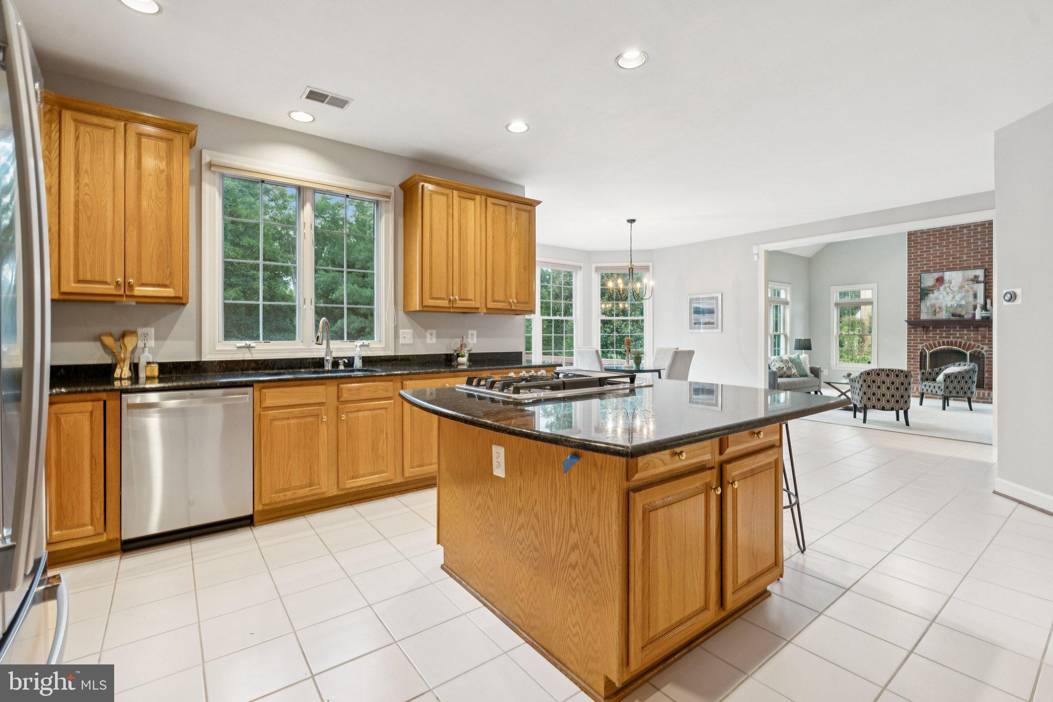 12213 Windsor Hall Way Herndon, VA 20170 - Photo 21 of 64 a kitchen with granite countertop a sink stove and cabinets