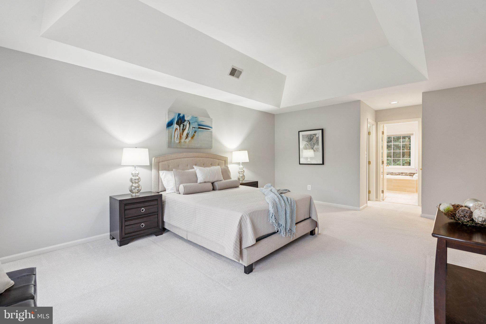 12213 Windsor Hall Way Herndon, VA 20170 - Photo 27 of 64 a spacious bedroom with a bed and a couch