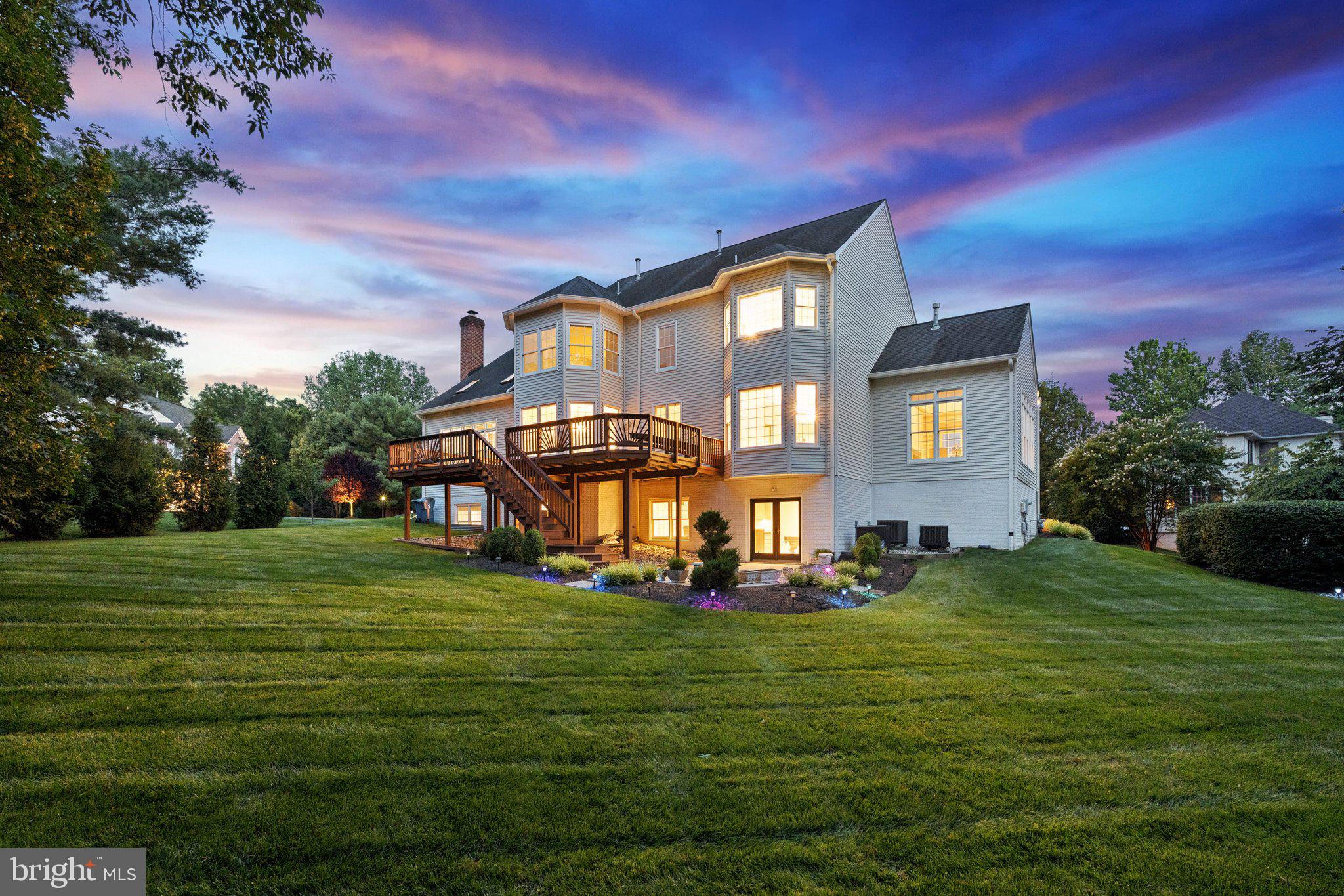 12213 Windsor Hall Way Herndon, VA 20170 - Photo 4 of 64 a front view of a house with a garden