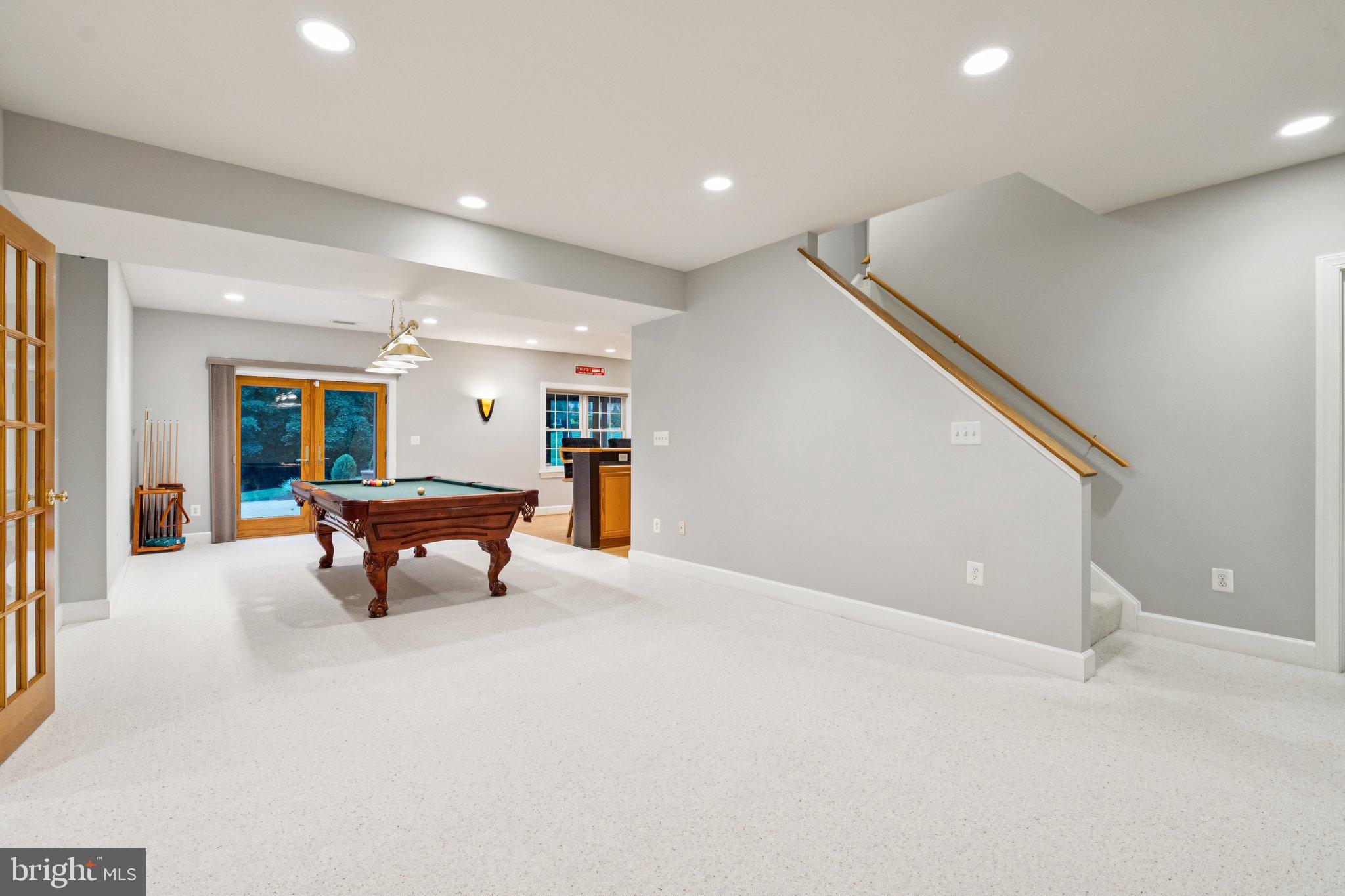 12213 Windsor Hall Way Herndon, VA 20170 - Photo 45 of 64 a view of an empty room with windows wooden floor and furniture