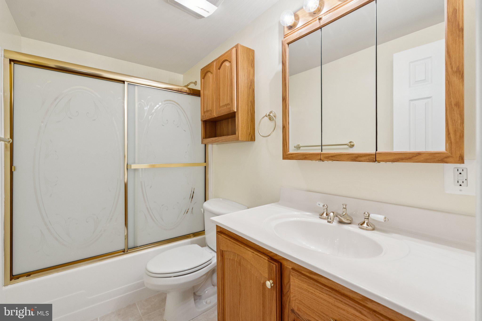 12213 Windsor Hall Way Herndon, VA 20170 - Photo 56 of 64 a bathroom with a sink a toilet and a mirror