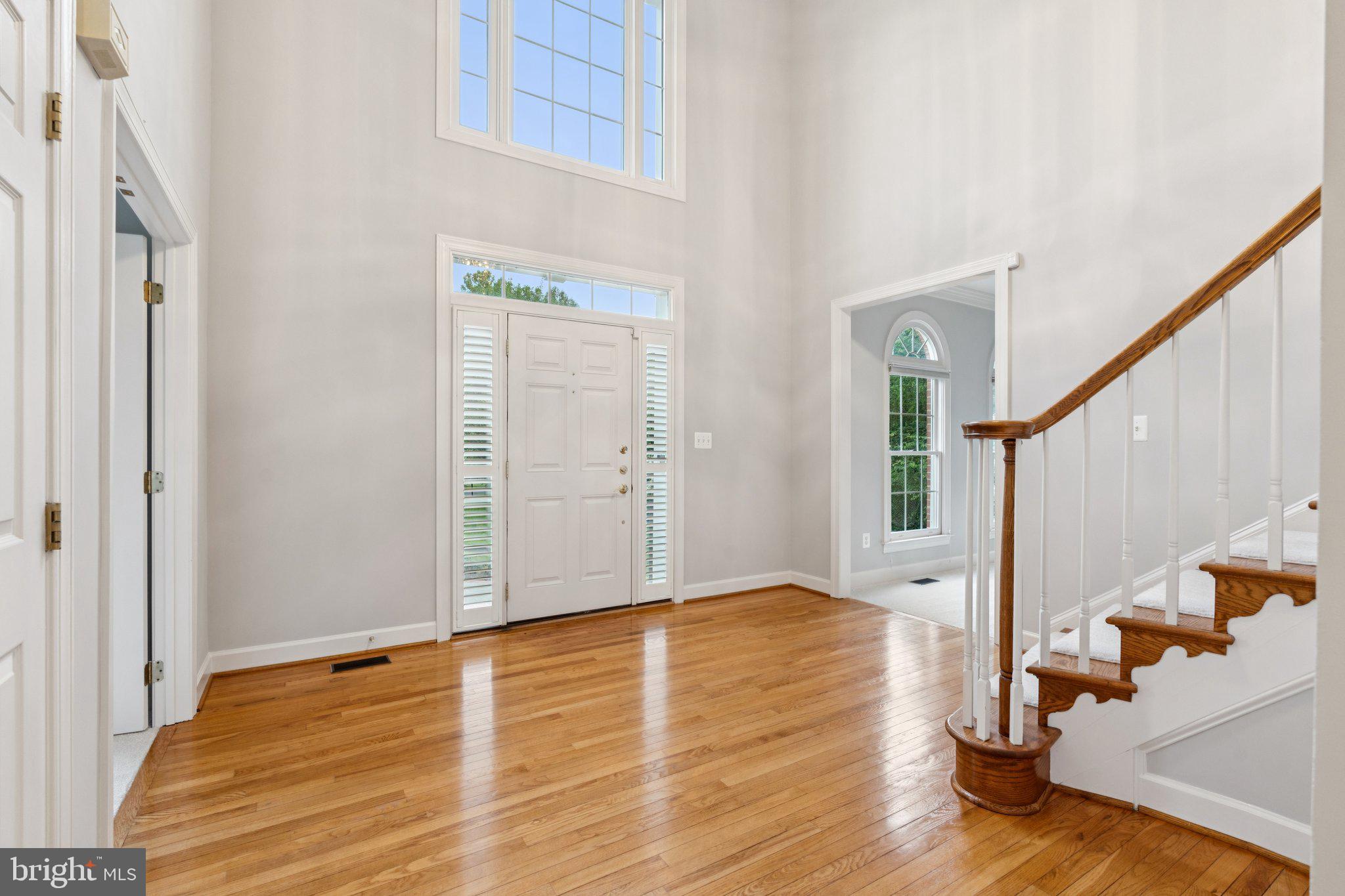 12213 Windsor Hall Way Herndon, VA 20170 - Photo 7 of 64 a view of an entryway with wooden floor