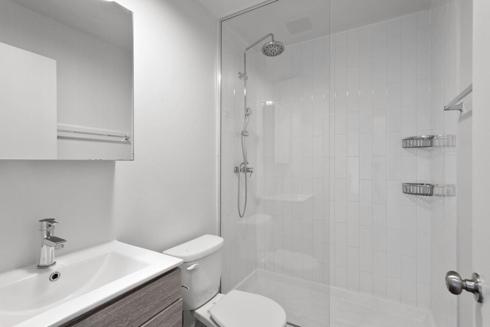 1325 West Wilson Avenue, Unit 1011 Chicago, IL 60640 - Photo 11 of 22 a bathroom with a sink toilet and shower