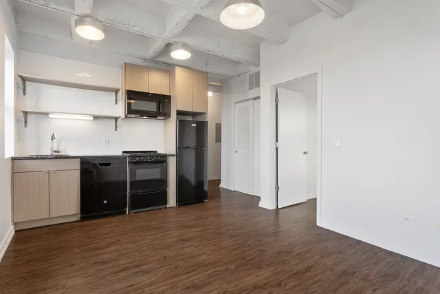 a kitchen with stainless steel appliances a refrigerator and a stove top oven