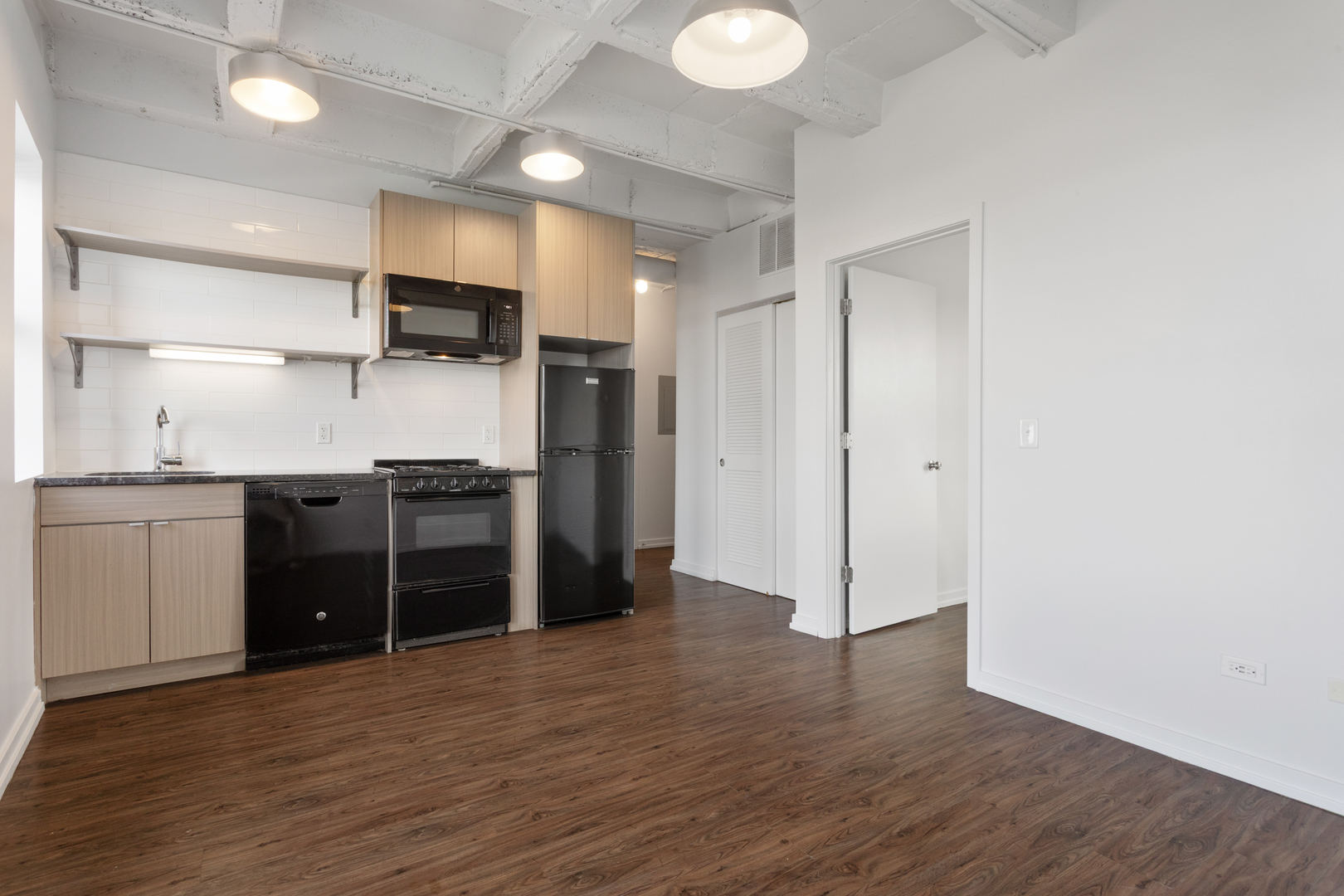 1325 West Wilson Avenue, Unit 1011 Chicago, IL 60640 - Photo 4 of 22 a kitchen with stainless steel appliances a refrigerator and a stove top oven