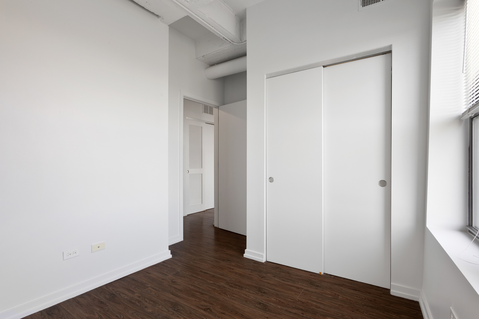 1325 West Wilson Avenue, Unit 1011 Chicago, IL 60640 - Photo 6 of 22 a view of an empty room with wooden floor