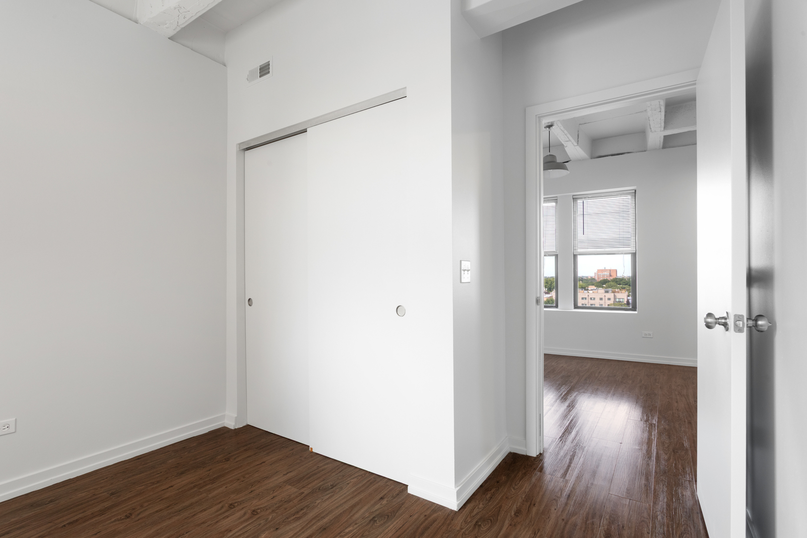 1325 West Wilson Avenue, Unit 1011 Chicago, IL 60640 - Photo 9 of 22 a view of hallway with wooden floor