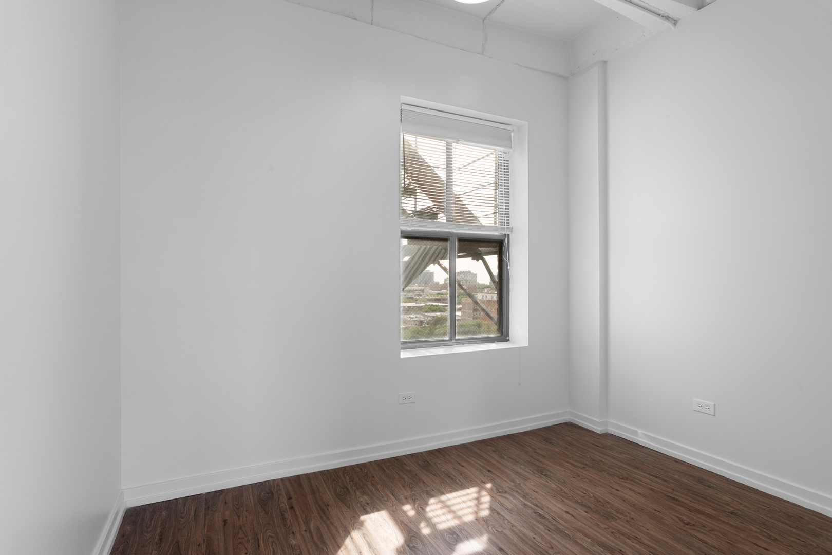 1325 West Wilson Avenue, Unit 1011 Chicago, IL 60640 - Photo 10 of 22 an empty room with wooden floor and windows
