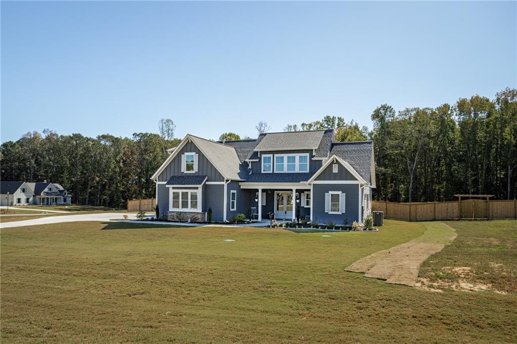 255 Old Town Road Dacula, GA 30019 - Photo 7 of 38 a view of a house with a big yard and large trees