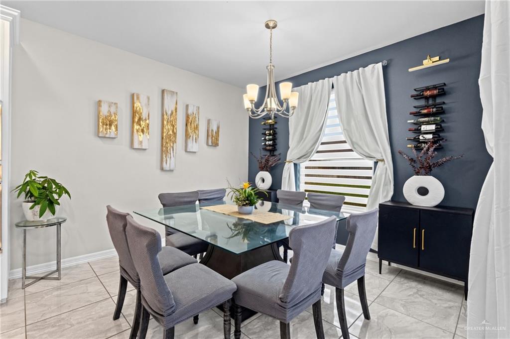 1904 Ridgeway Circle Edinburg, TX 78542 - Photo 8 of 32 Dining area featuring a glass-top table, six upholstered chairs, and a contemporary chandelier
