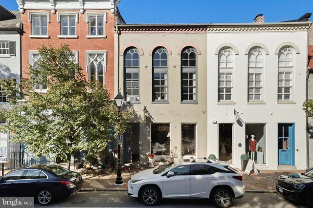 a front view of a building with parking space