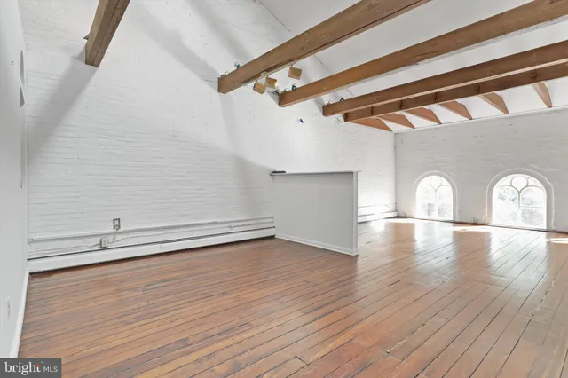 a bathroom with a sink a light fixture and a mirror