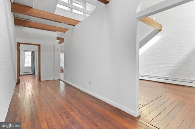 a view of a kitchen with refrigerator and windows