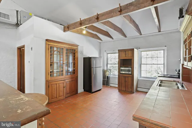 a kitchen with refrigerator and window