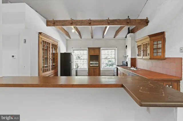 a hallway with windows and furniture