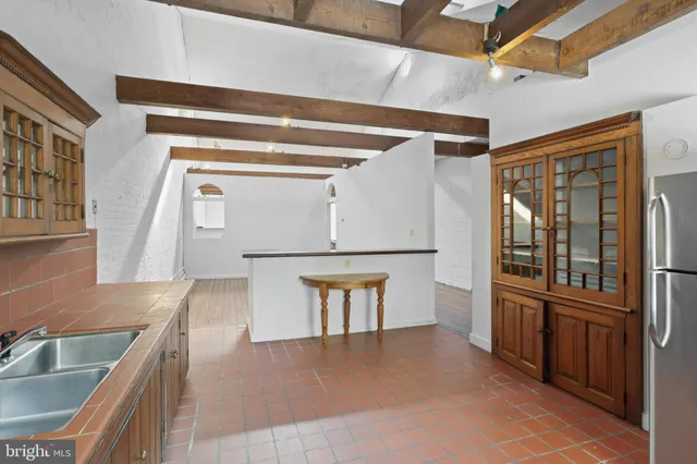 a kitchen with stainless steel appliances a refrigerator and a sink