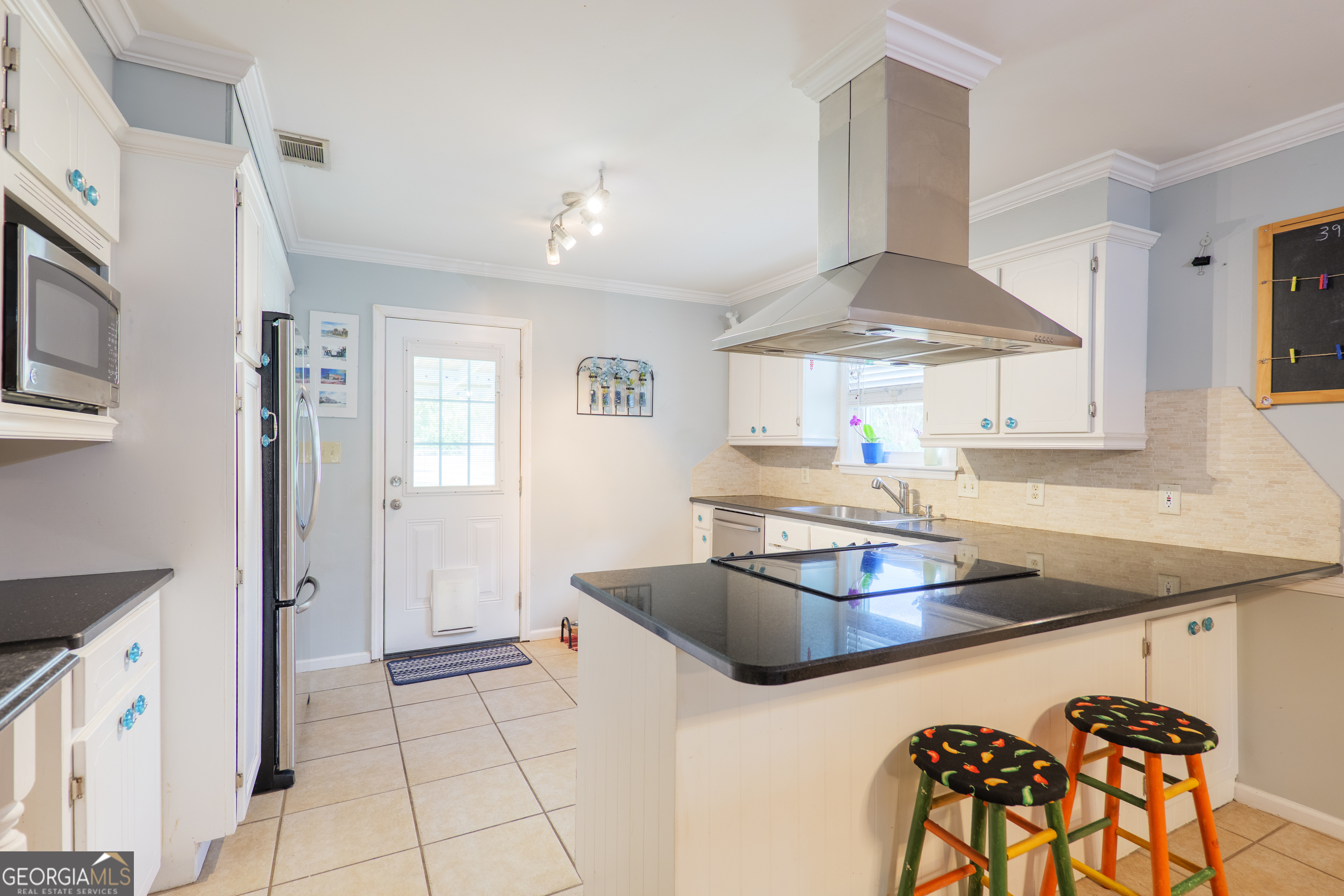 3937 Studstill Road Valdosta, GA 31605 - Photo 11 of 29 a kitchen with a stove a refrigerator and a table