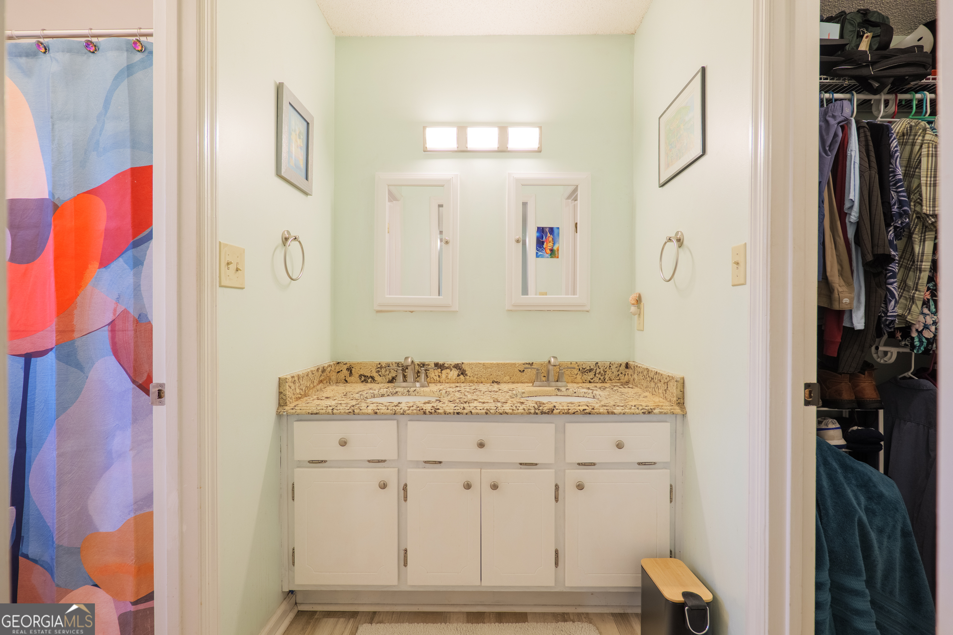 3937 Studstill Road Valdosta, GA 31605 - Photo 19 of 29 a bathroom with a granite countertop sink a mirror and shower