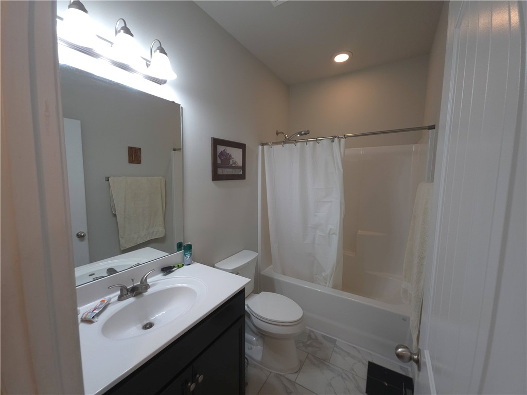 3 Cringle Lane Anderson, SC 29625 - Photo 14 of 26 A well-appointed bath features a sleek vanity, an illuminated mirror, and a shower-tub combination.