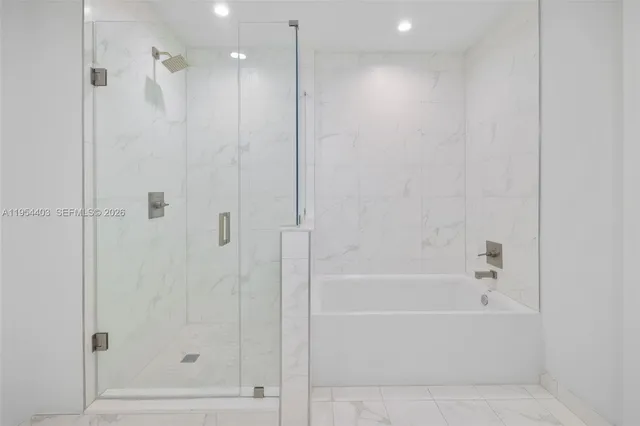 a spacious bathroom with a double vanity and a shower