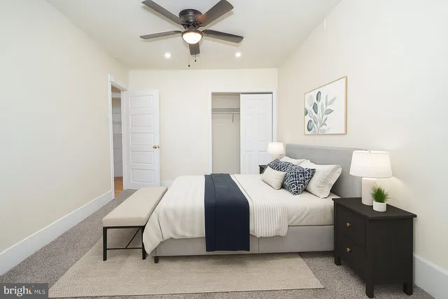 a bedroom with a large bed and a chandelier