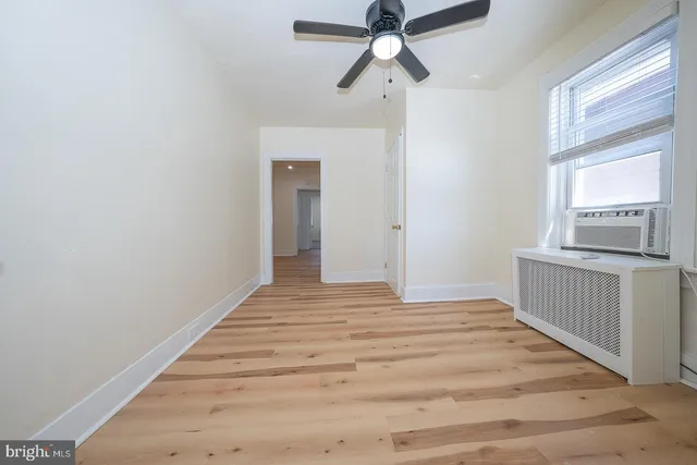 a view of a hallway view with wooden floor and a window