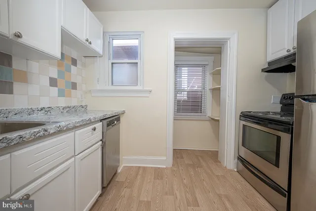 a kitchen with granite countertop a stove and a sink