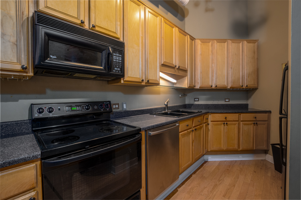 801 South Wells Street, Unit 102 Chicago, IL 60607 - Photo 12 of 26 a kitchen with a stove microwave and sink