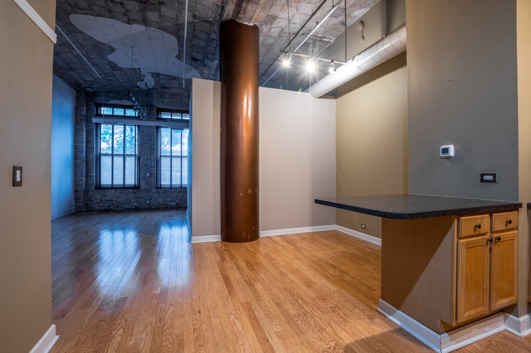 801 South Wells Street, Unit 102 Chicago, IL 60607 - Photo 9 of 26 a view of hallway with wooden floor