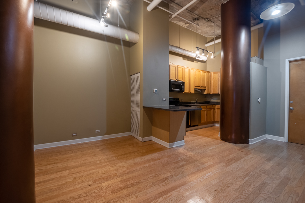 801 South Wells Street, Unit 102 Chicago, IL 60607 - Photo 10 of 26 a view of a kitchen with a refrigerator and a window