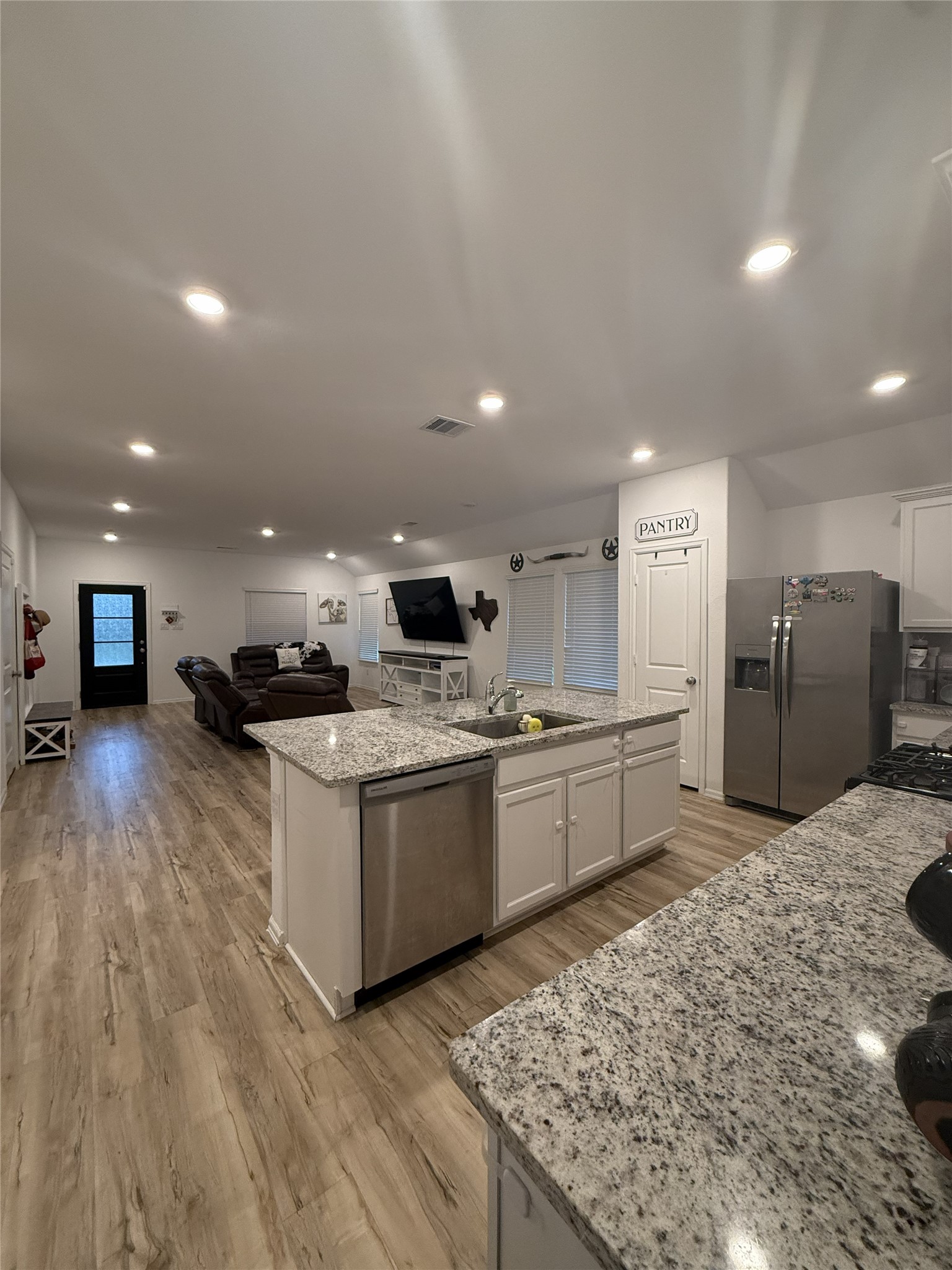 5323 Winding Strm Drive Rosenberg, TX 77469 - Photo 6 of 13 a large kitchen with stainless steel appliances kitchen island granite countertop a large counter top and wooden floors