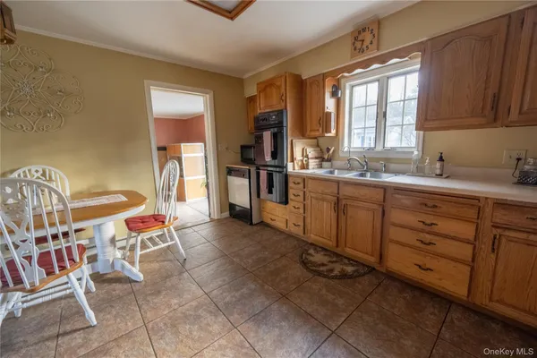 a open kitchen with stainless steel appliances kitchen island granite countertop a sink and cabinets