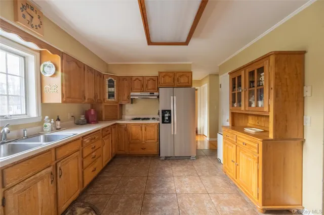 a kitchen with a sink and refrigerator