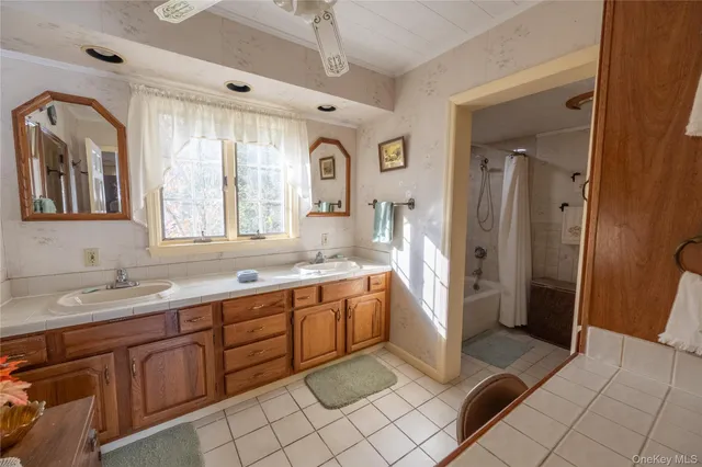 a spacious bathroom with a granite countertop sink mirror and a shower