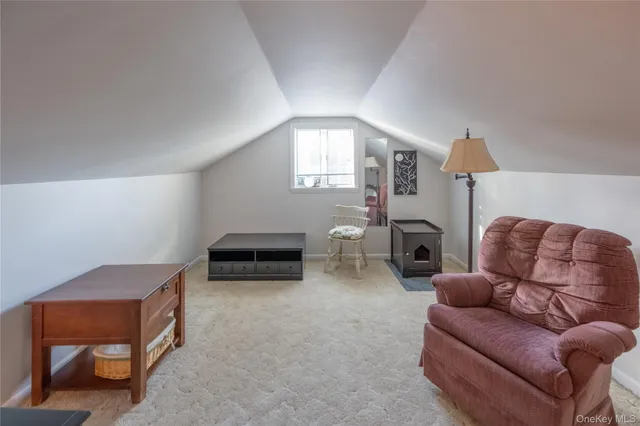 a living room with furniture and a lamp