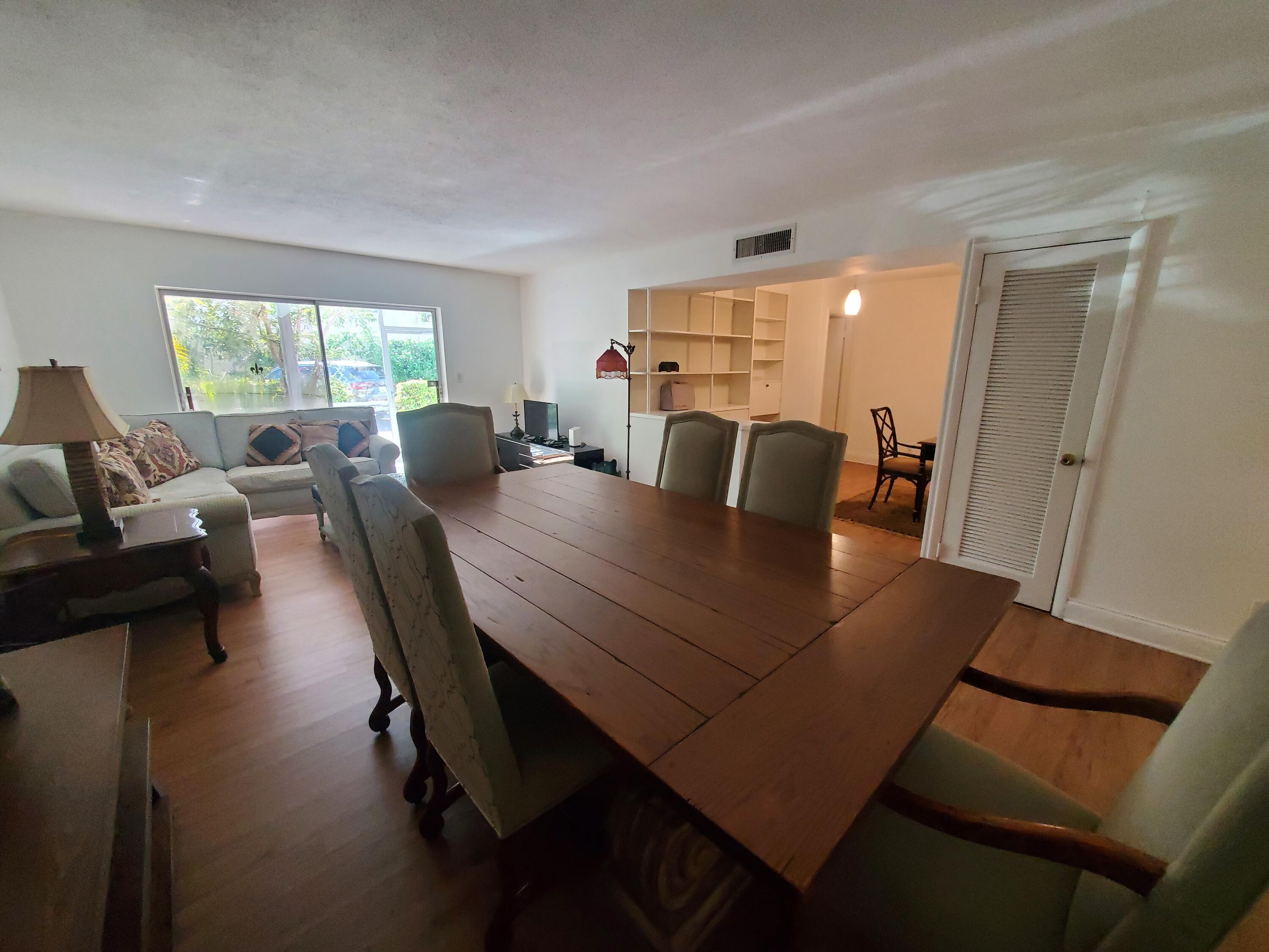 20 Southeast 13th Street, Unit A6 Boca Raton, FL 33432 - Photo 3 of 14 a view of a dining room with furniture and wooden floor