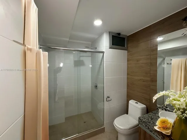 a kitchen with stainless steel appliances kitchen island granite countertop a sink dishwasher stove and refrigerator