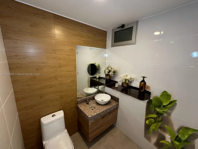 a living room with furniture window and a flat screen tv