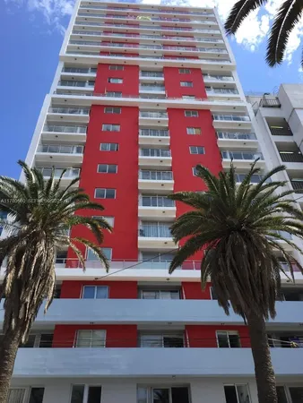 a front view of multi story residential apartment building with yard
