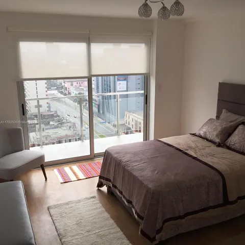 a balcony with furniture and a potted plant