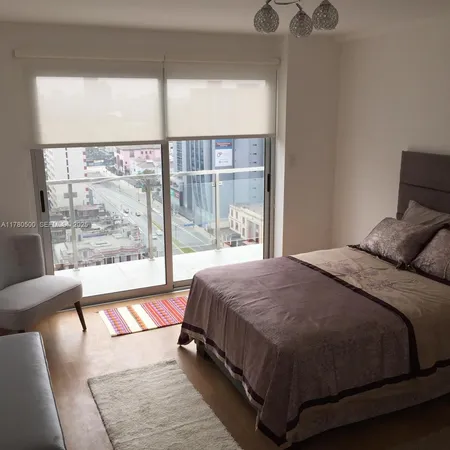 a balcony with furniture and a potted plant