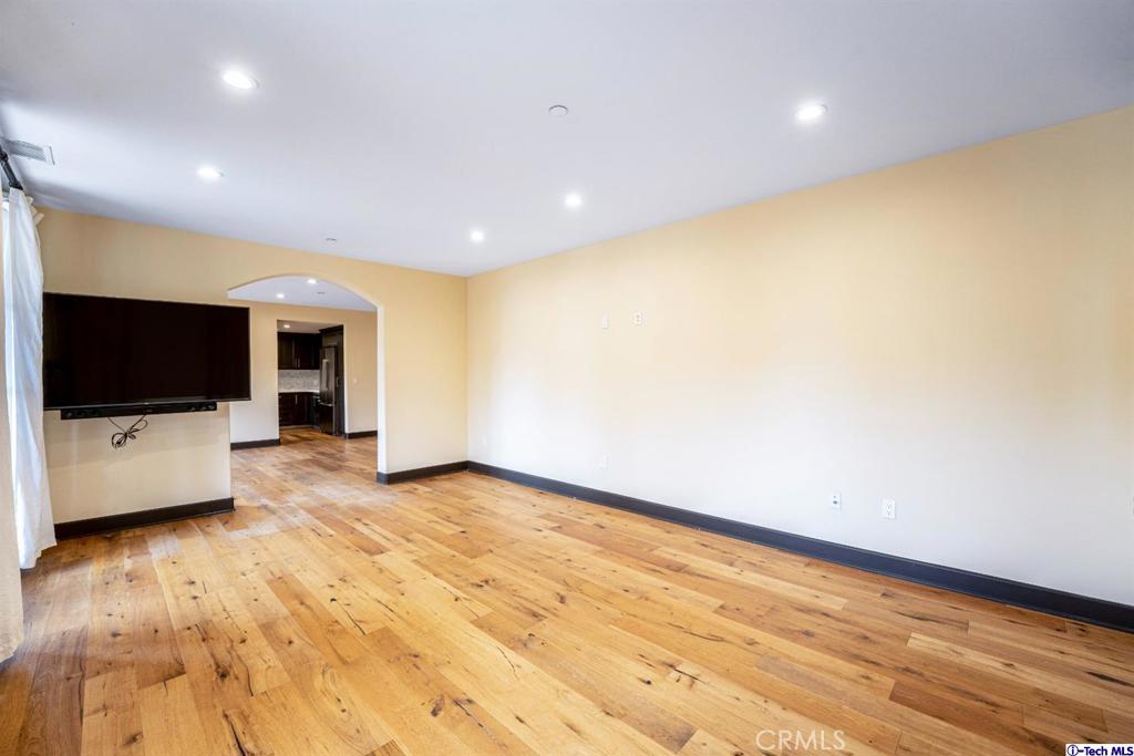 10523 Ashton Avenue, Unit 202 Los Angeles, CA 90024 - Photo 25 of 36 a view of room with wooden floor and flat screen tv