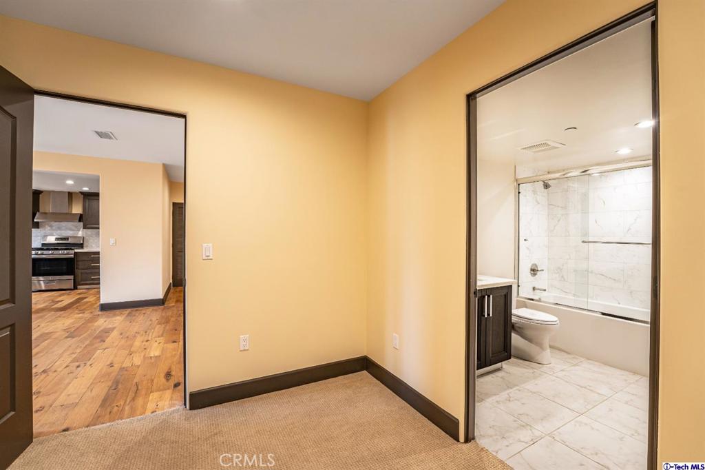 10523 Ashton Avenue, Unit 202 Los Angeles, CA 90024 - Photo 32 of 36 a view of a bathroom with a glass door shower