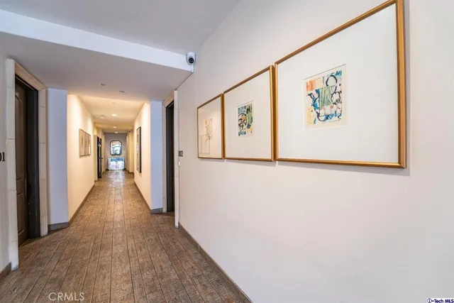 a view of a hallway with wooden floor