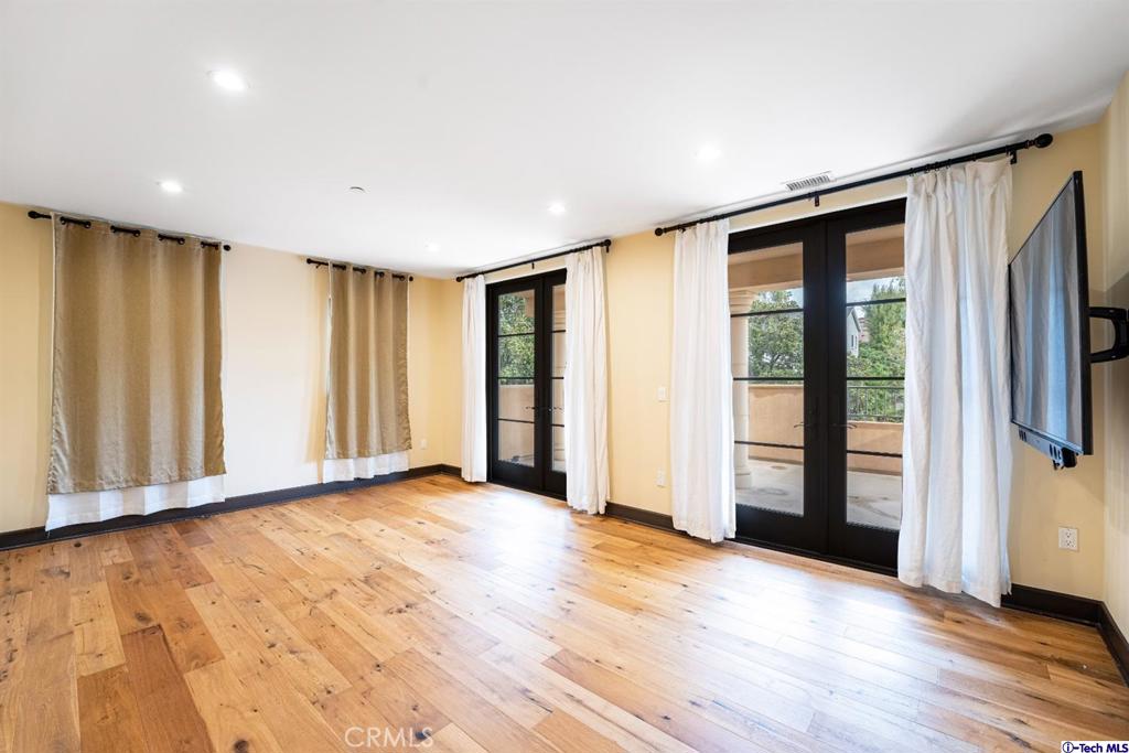 10523 Ashton Avenue, Unit 202 Los Angeles, CA 90024 - Photo 7 of 36 a view of an empty room with a window and wooden floor