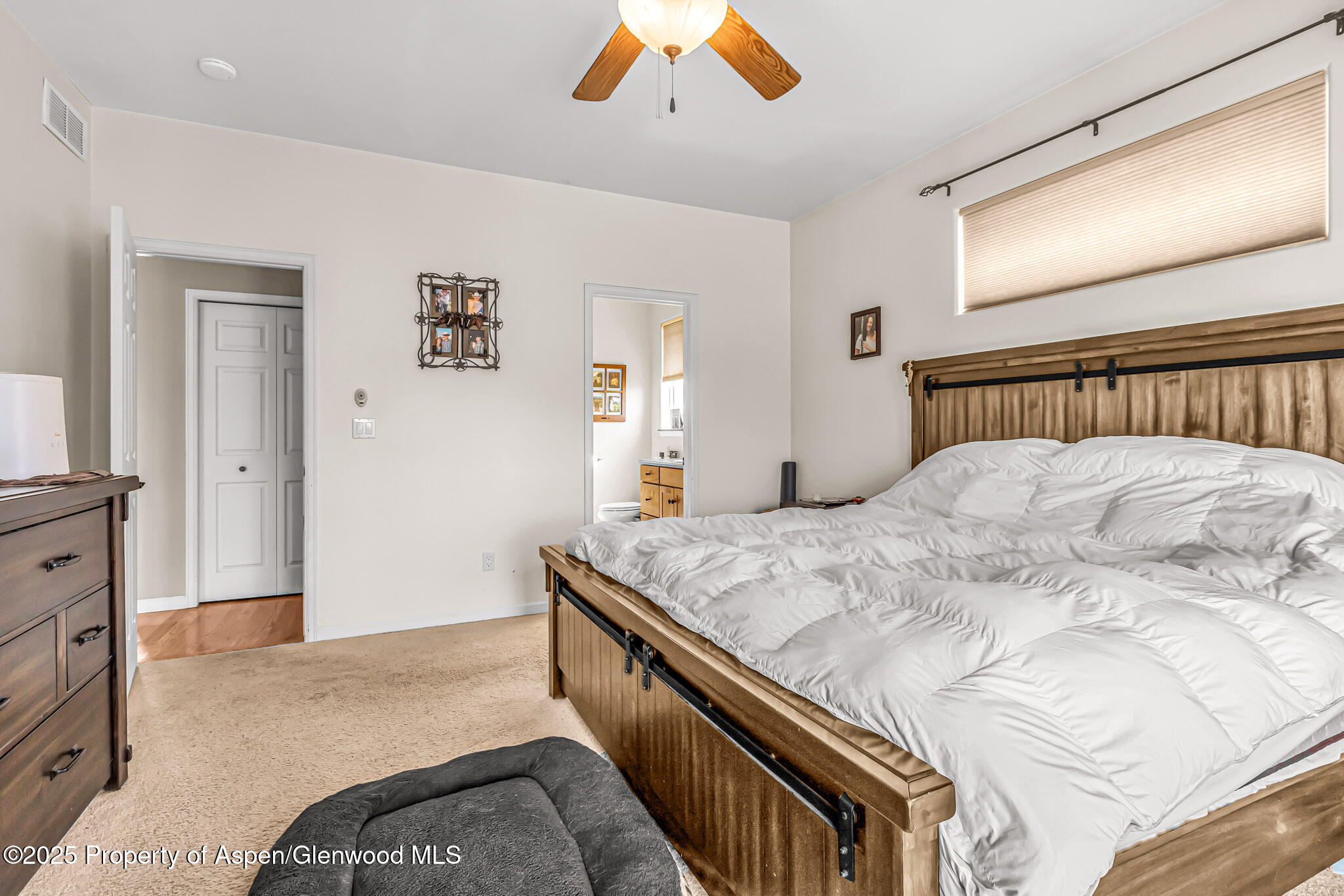 1357 West Spruce Court Rifle, CO 81650 - Photo 16 of 38 a bedroom with a bed and a dresser