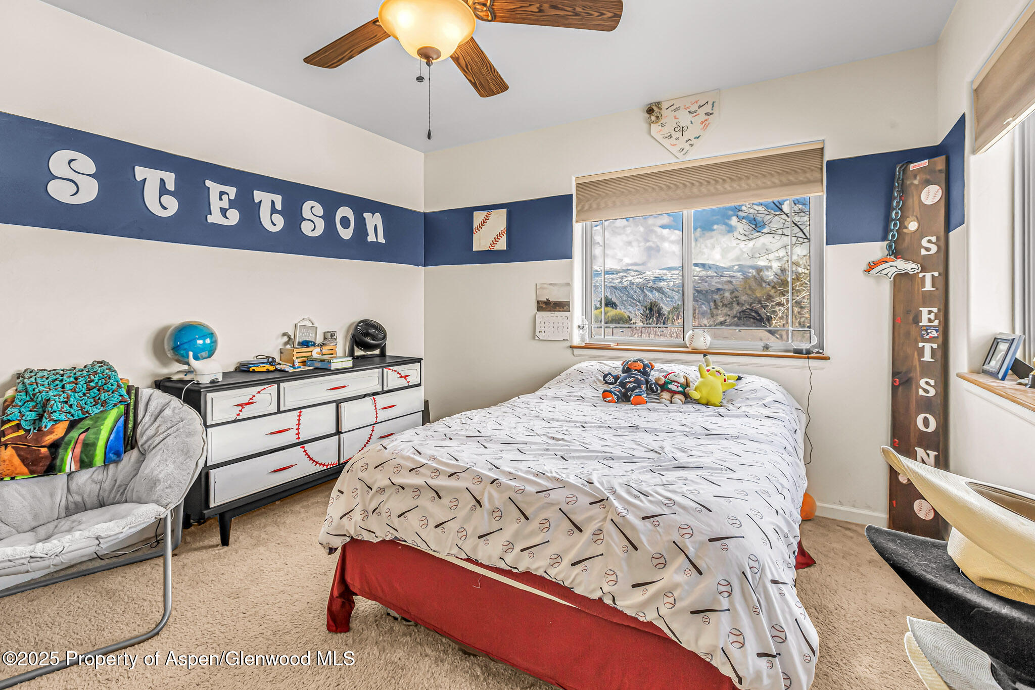 1357 West Spruce Court Rifle, CO 81650 - Photo 18 of 38 a bedroom with a bed a couch and a chandelier