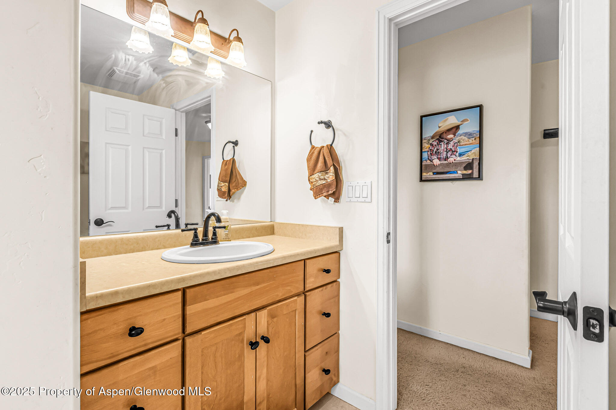 1357 West Spruce Court Rifle, CO 81650 - Photo 22 of 38 a bathroom with a double vanity sink and a mirror
